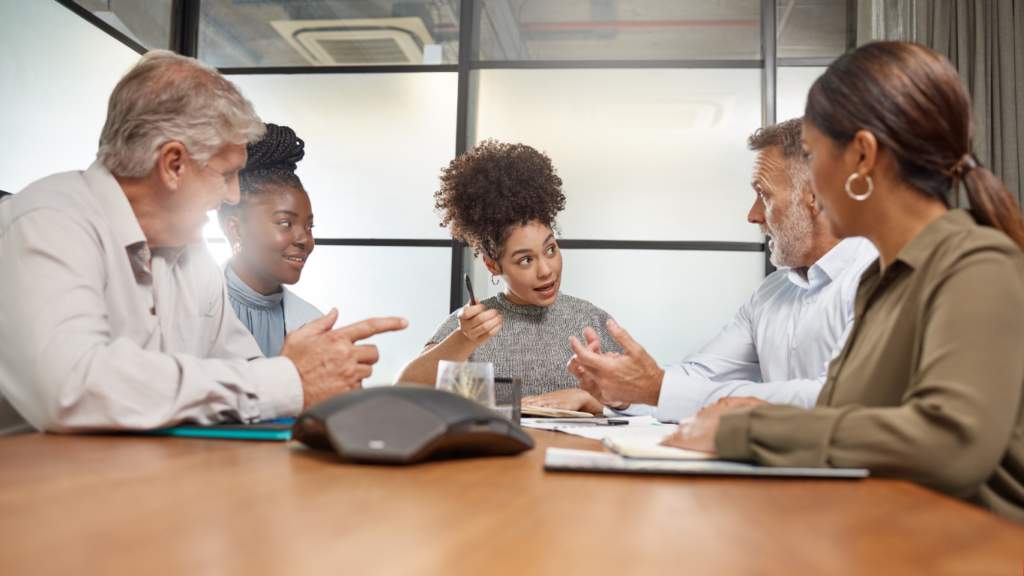 Employee having a face-to-face conversation instead of texting, representing workplace communication skills