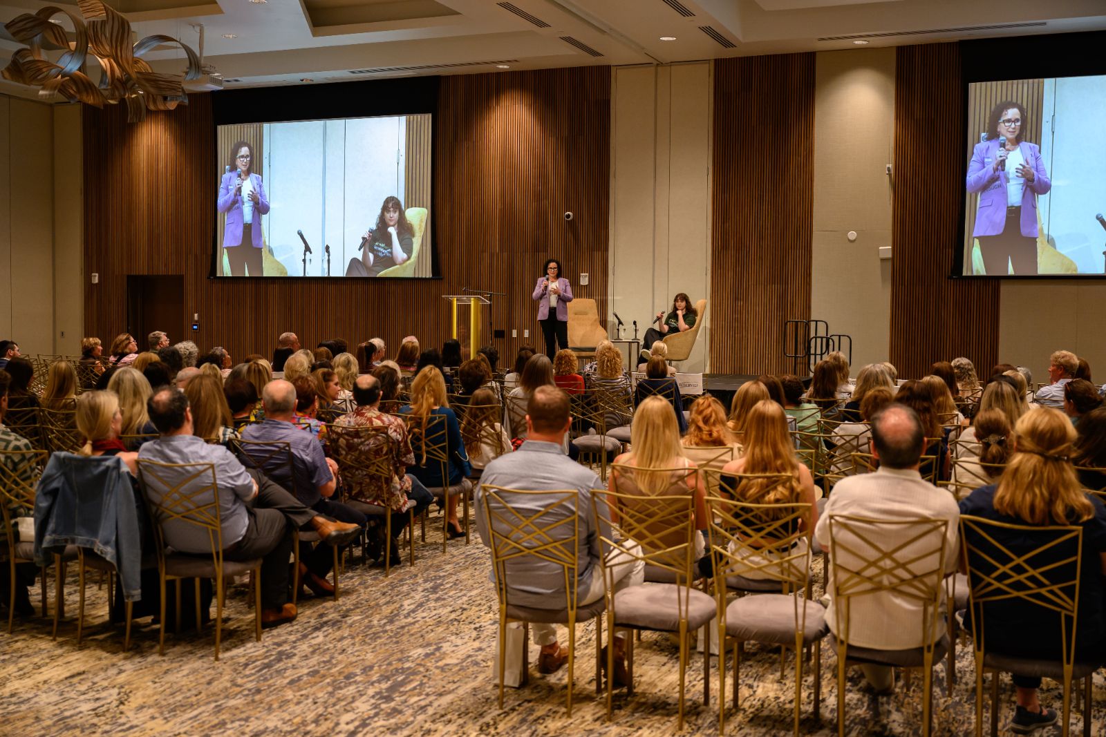 Simone Knego, keynote speaker for HR and L&D teams, speaking to a conference audience