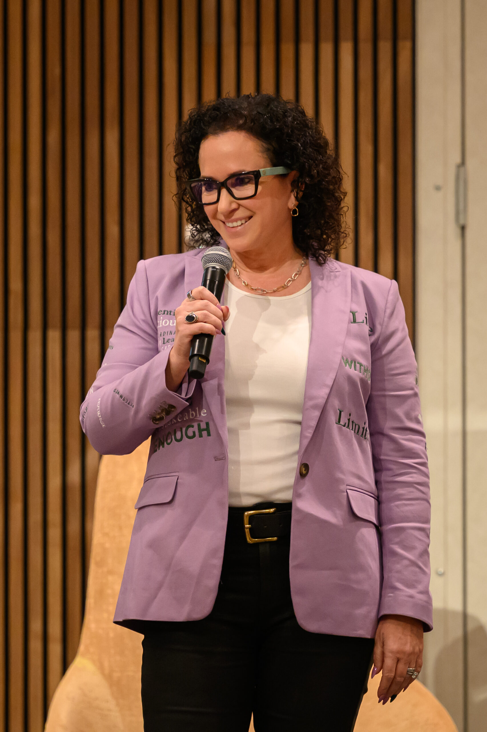 Simone Knego, keynote speaker for sales teams, speaking with a microphone