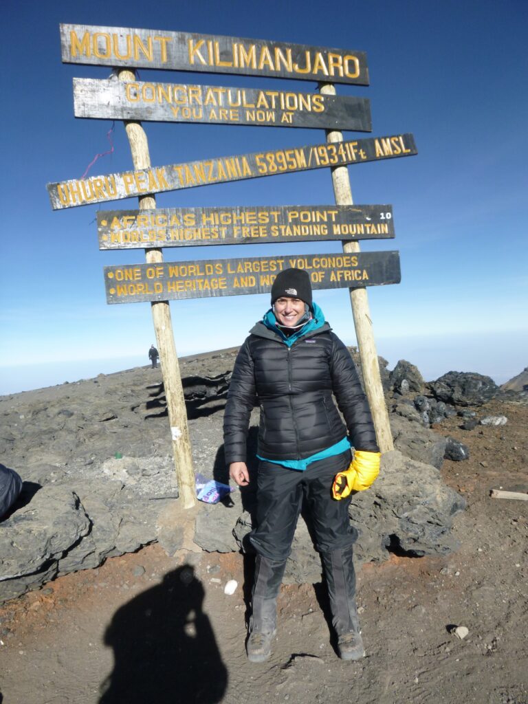 Simone Knego at the summit of Mount Kilimanjaro